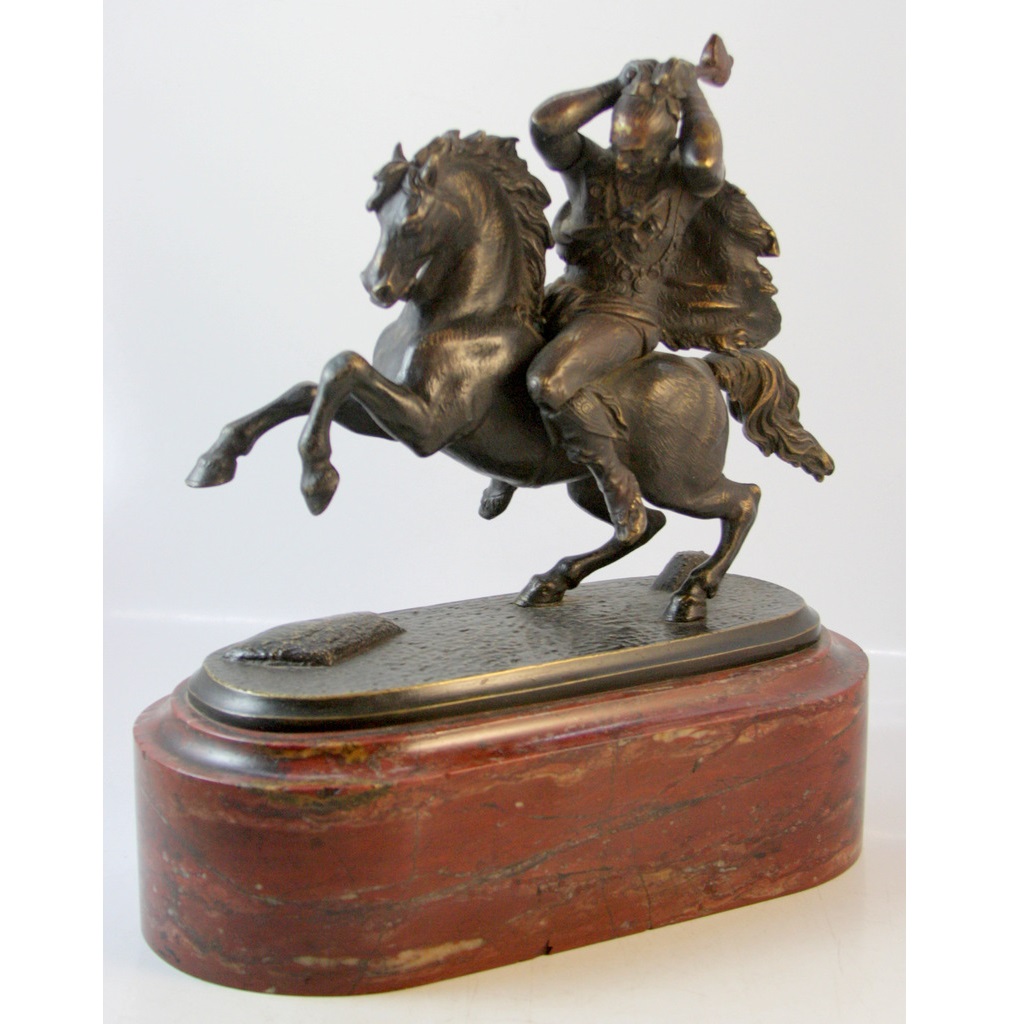 BRONZE STATUE OF A WARRIOR MOUNTING A HORSE